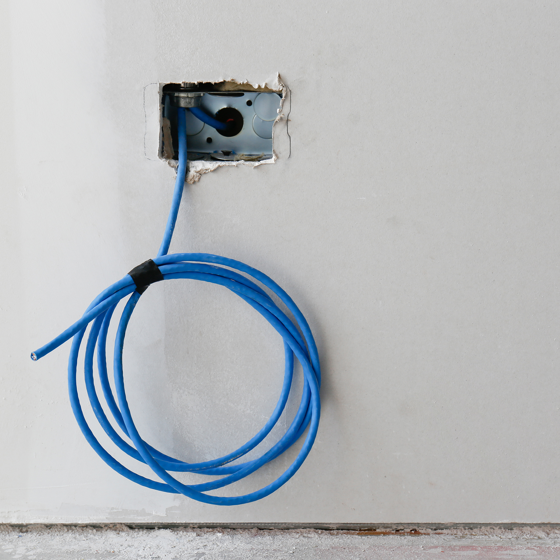 A blue cable hanging out of a wall - For wifi and cabling installations page